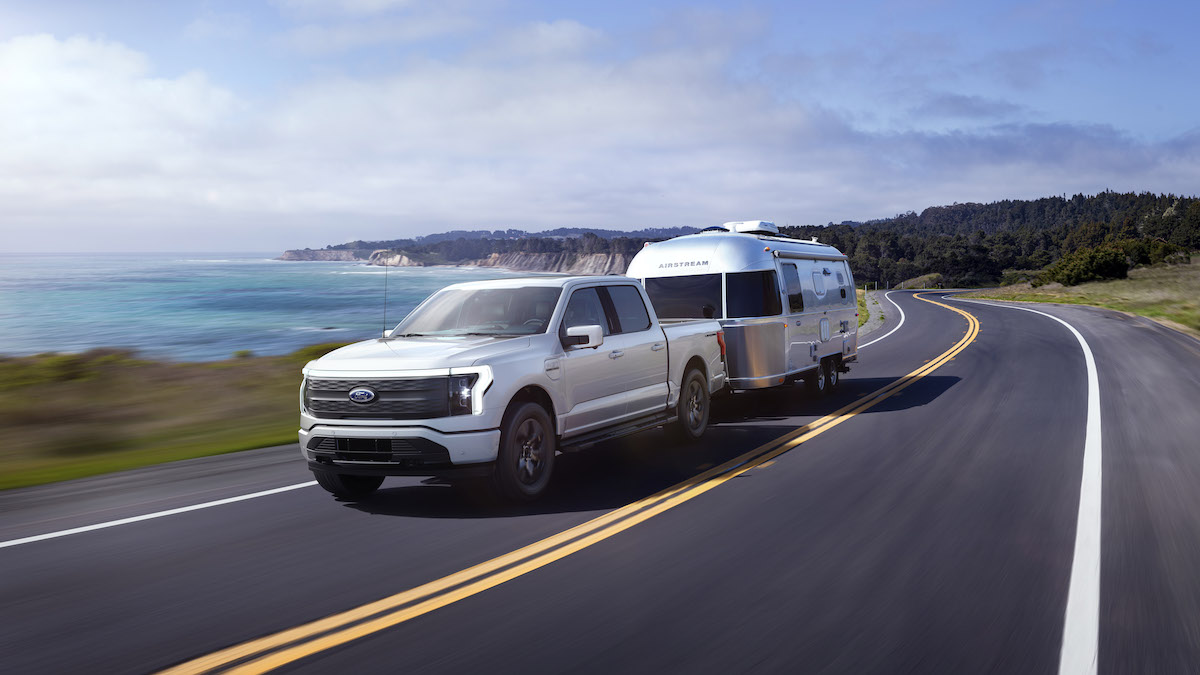 A Ford F-150 Lightning towing an airstream camper