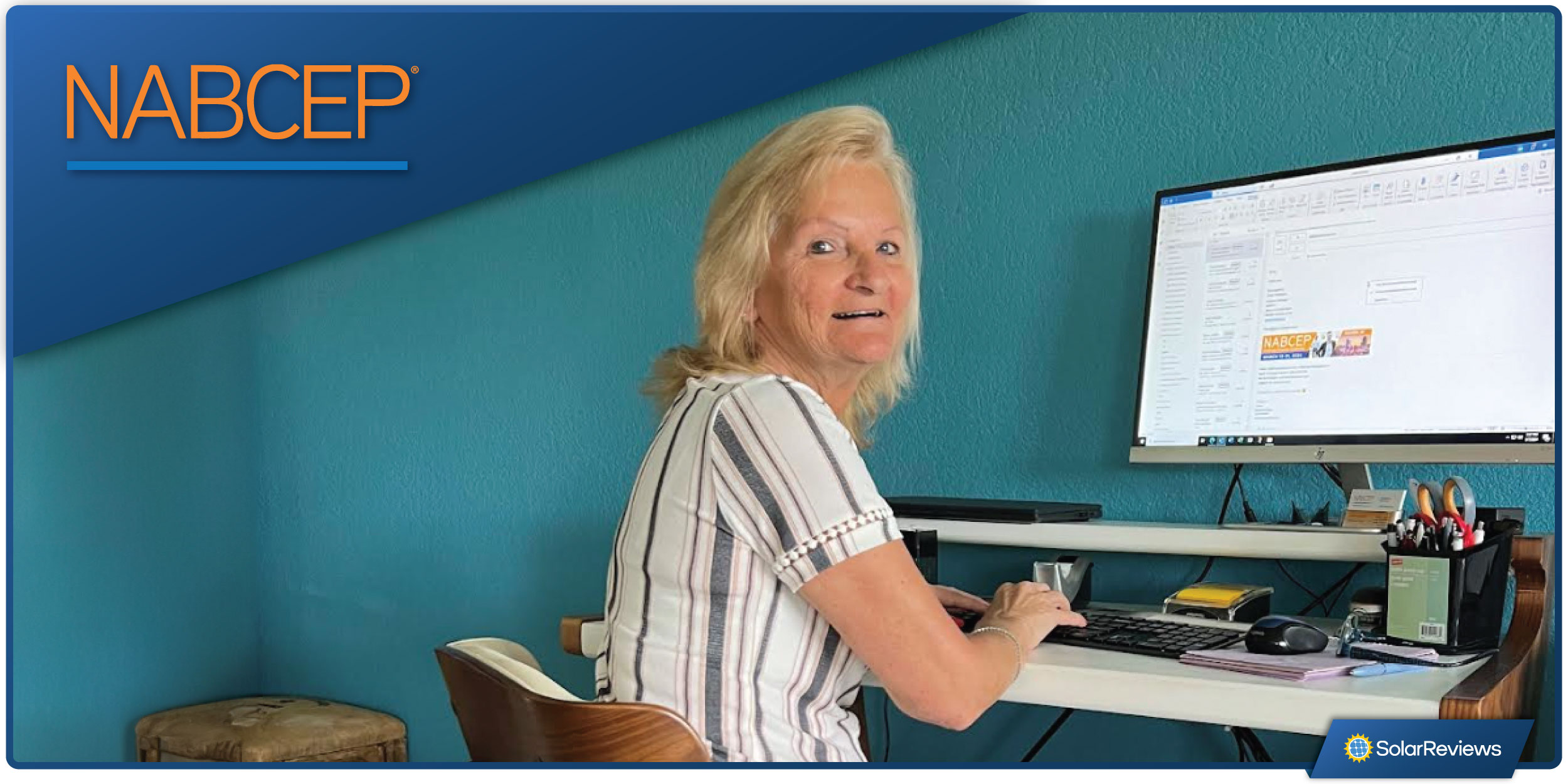 Women sitting at a desk with a computer next to the NABCEP company logo